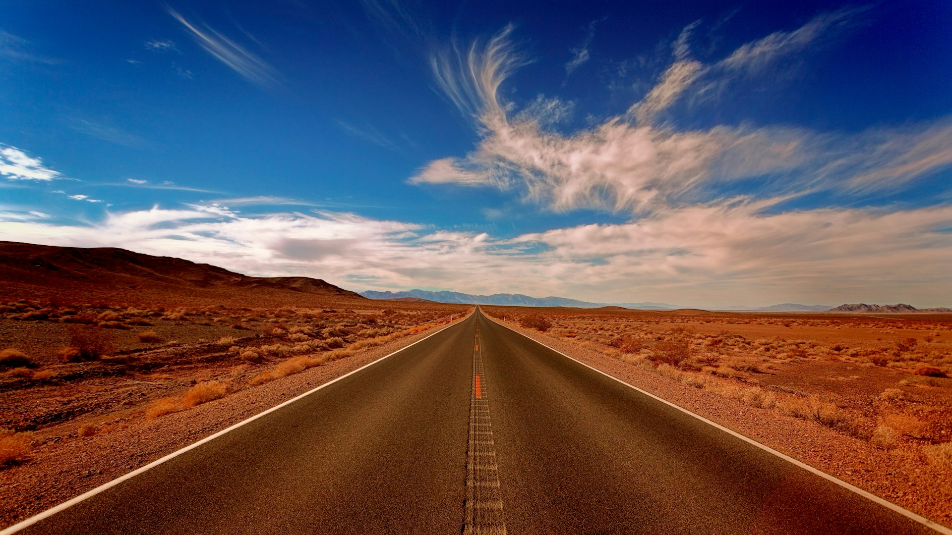 Image of an open road with a clear blue sky 