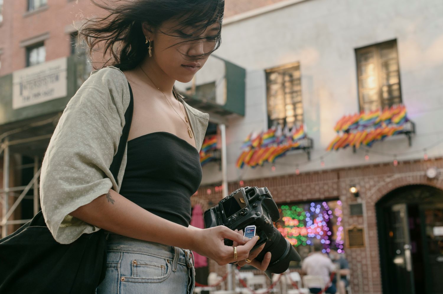 Female inserting a Samsung memory card into her camera