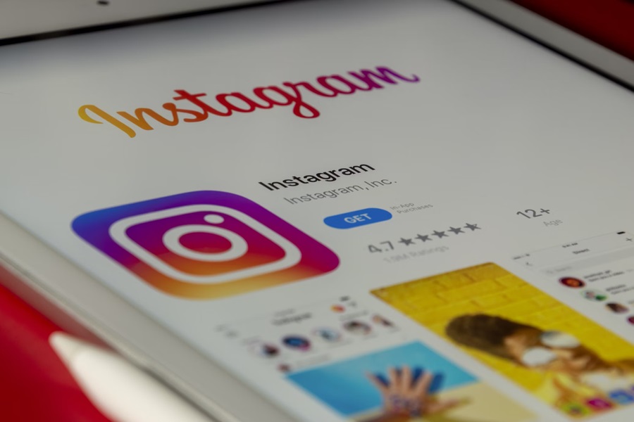 An image of a mobile device displaying the Instagram logo on the screen.