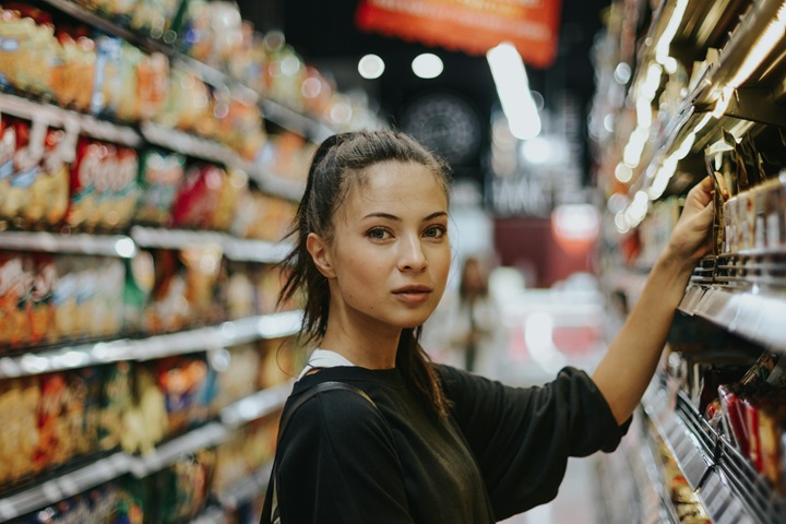 Image of a woman choosing items in a supermarket