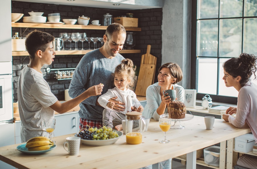Family is preparing for breakfast, they are in good mood and ready to start new day.