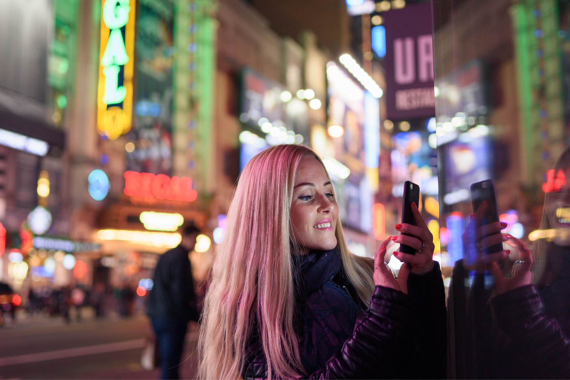 A young lady is watching her smart phone
